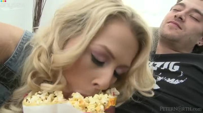 Curly blond haired chick throws popcorn away and sucks dude's cock